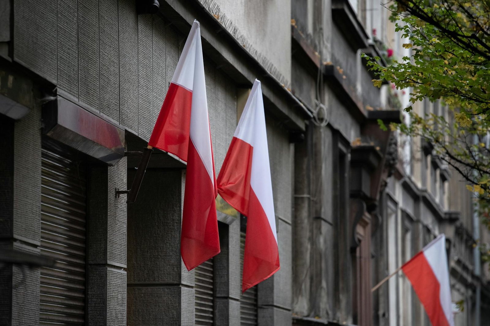 Polish flags on historic building in Warsaw